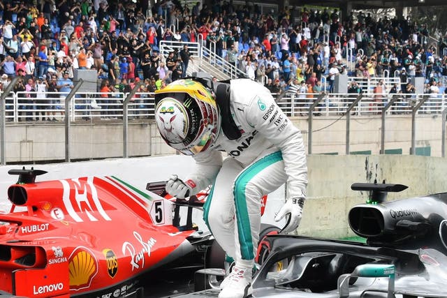 Lewis Hamilton celebrates on top of his Mercedes