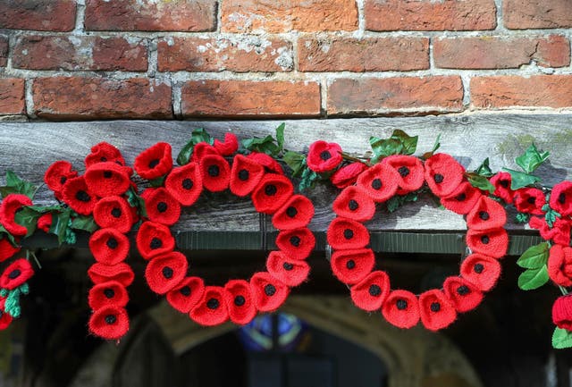 Knitted poppies form the number 100 over the doorway into St John the Baptist Church in North Baddesley, Hampshire