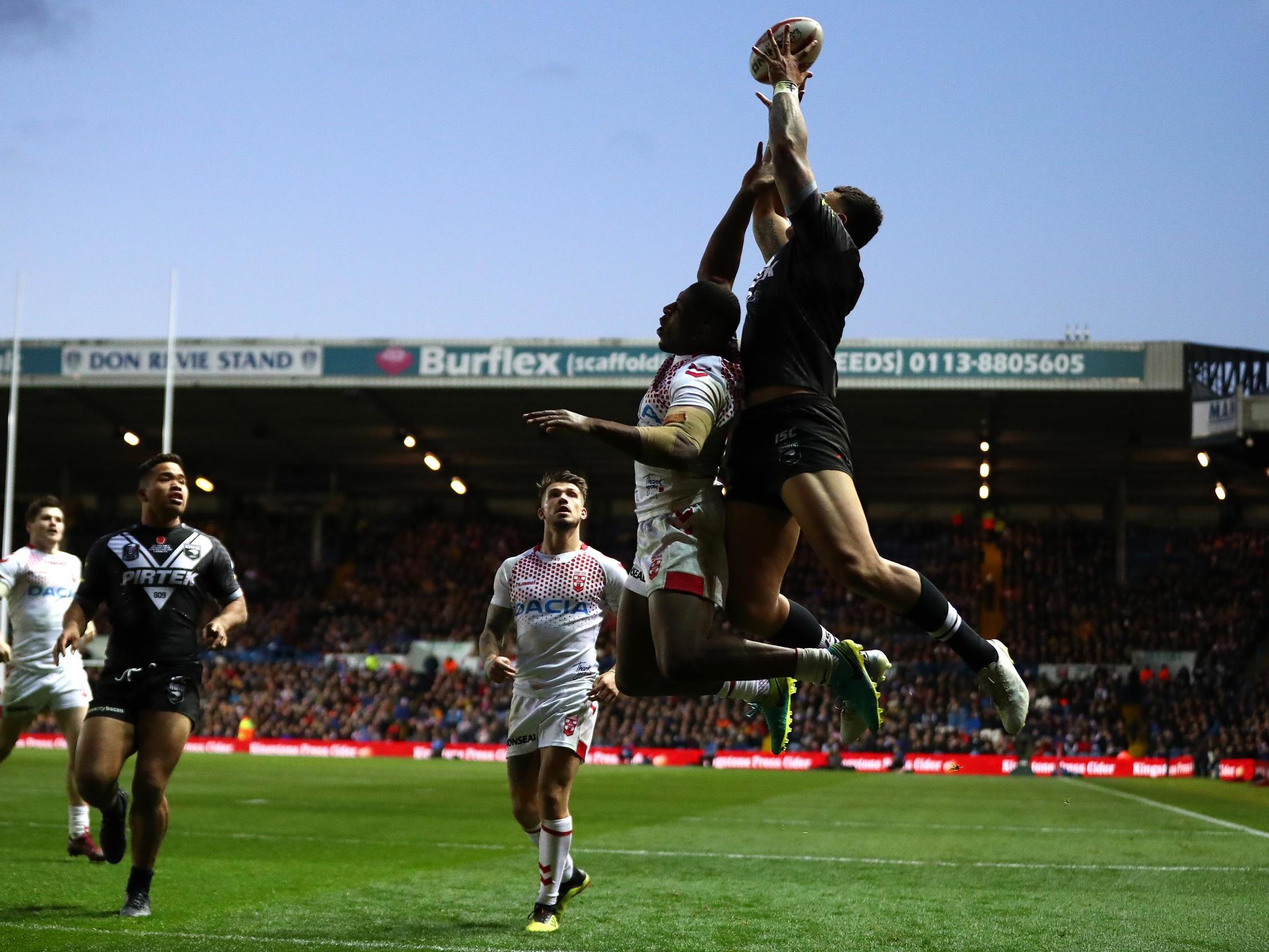 Ken Maumalo claims the high ball ahead of Jermaine McGillvary before touching down to score