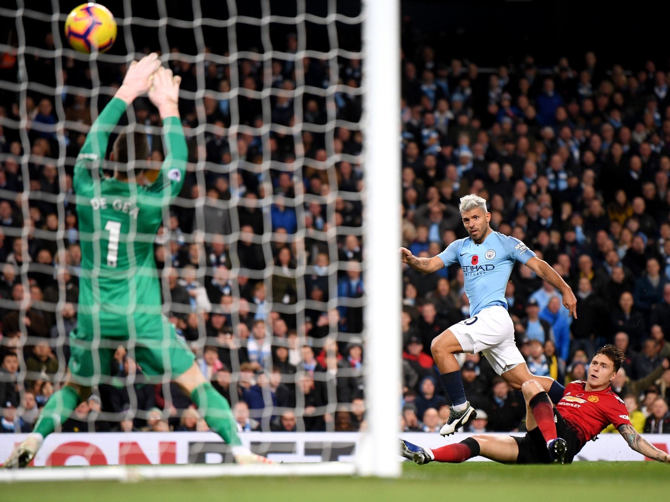 Aguero fires the ball above David De Gea for City's second goal