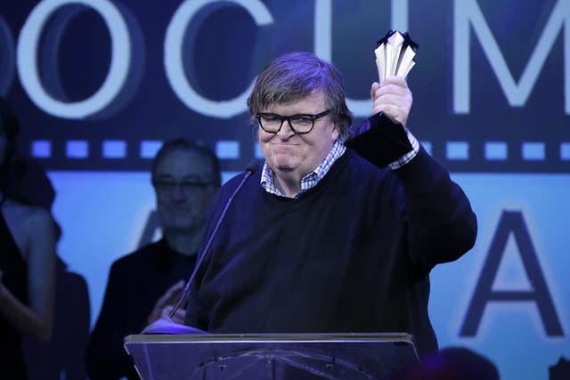 Michael Moore receives an award during the 3rd Annual Critics' Choice Documentary Awards