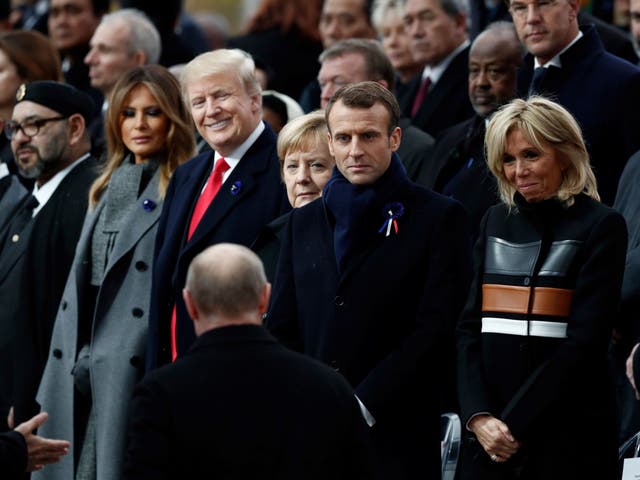 Donald Trump beams at the approach of Vladimir Putin in Paris