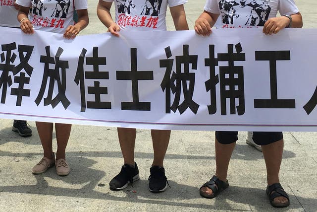 People hold banners at a demonstration in support of factory workers of Jasic Technology, in Pingshan district, China on 6 August 2018