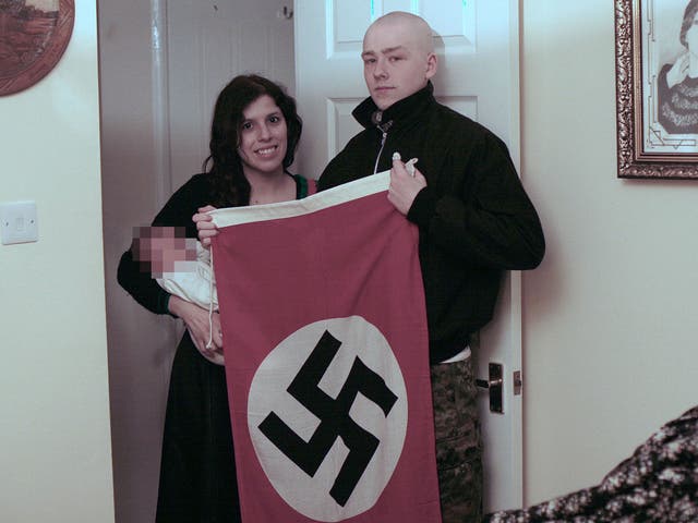 Adam Thomas and Claudia Patatas posed for pictures with their son alongside Nazi paraphernalia