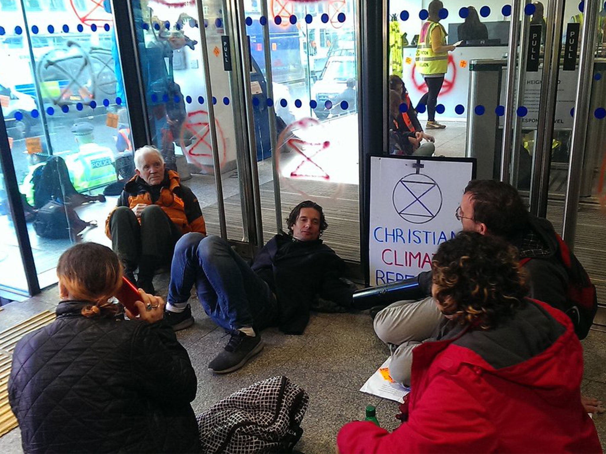 Climate change protesters chain themselves together and block entrances at energy department offices in Westminster
