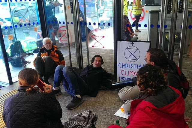 Demonstrators daubed the doors and blocked the entrances to the building before one woman was arrested