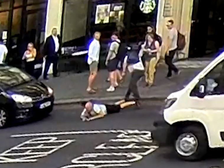 CCTV footage showed a car braking sharply after a pedestrian was apparently shoved from behind