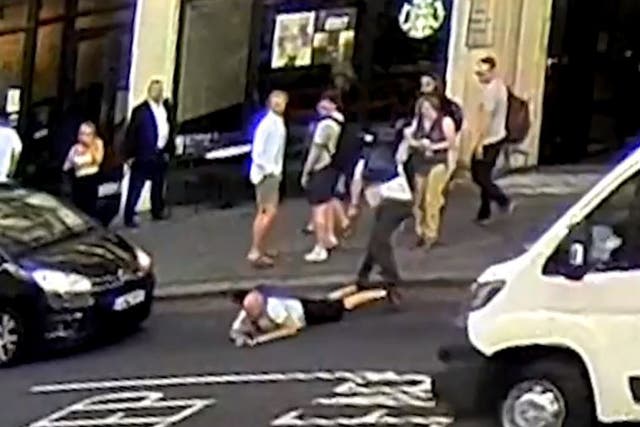 A man is pushed into the road in central London on Monday, 23 July 2018
