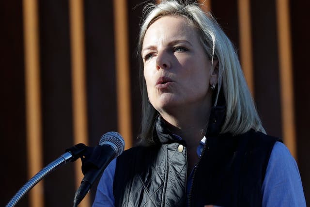Homeland security secretary Kirstjen Nielsen speaks in front of a newly fortified border wall structure in October 2018