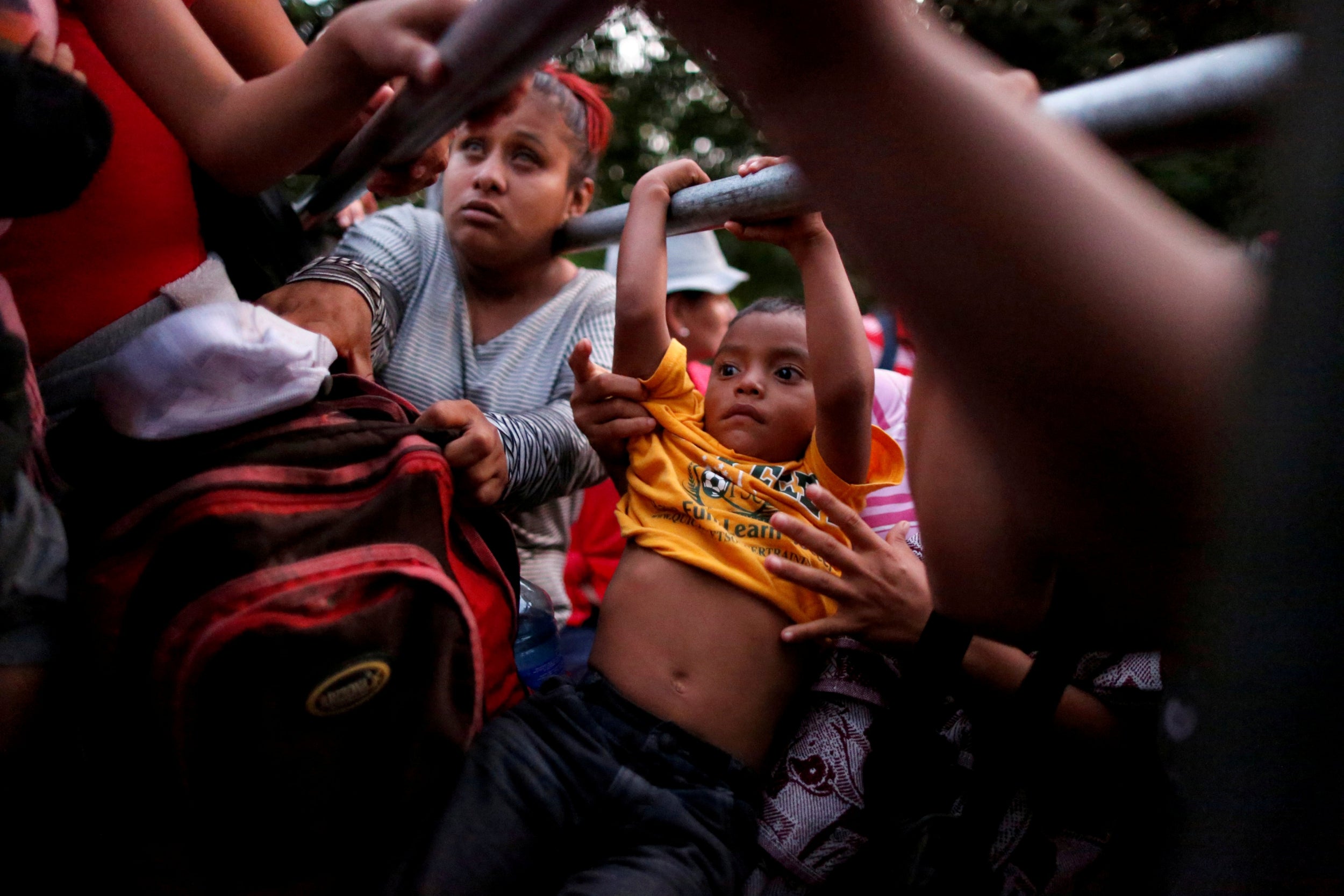 Migrants from El Salvador board a pickup truck in Guatemala to hitchhike along the highway to help them get closer to the US