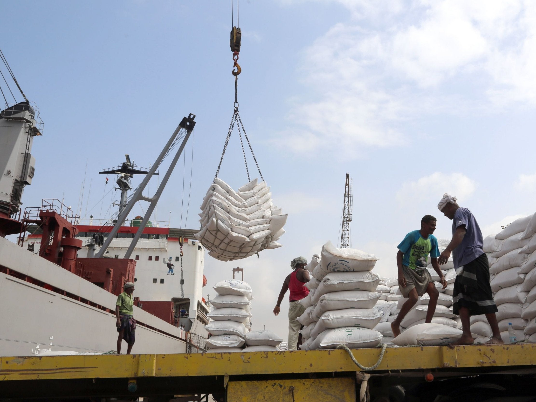 Workers unload wheat provided by UNICEF at the Red Sea port of Hodeidah in January (AFP/Getty)