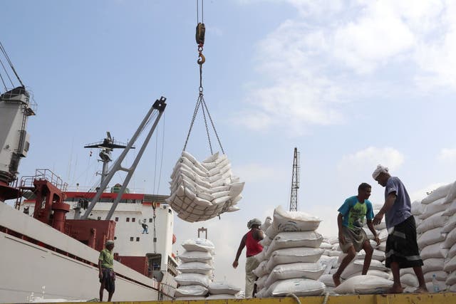 Workers unload wheat assistance provided by Unicef from a cargo ship at the Red Sea port of Hodeidah in January