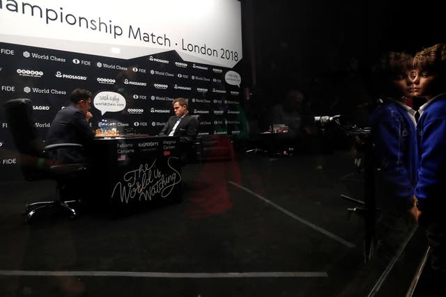 Fabiano Caruana (L) and Magnus Carlsen in the heat of battle