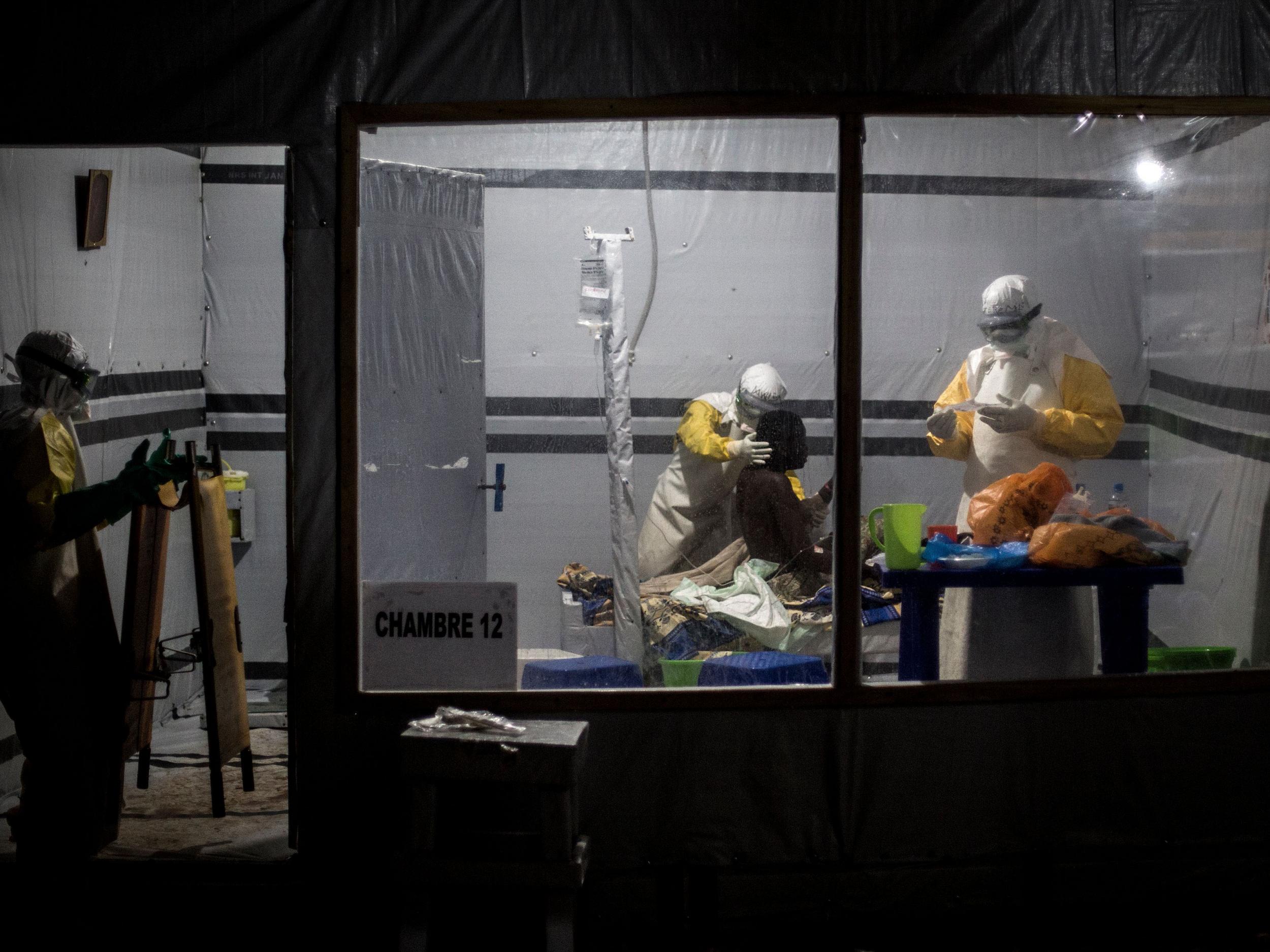 Health workers treat an unconfirmed Ebola patient, inside a treatment centre on November 3, 2018 in Butembo, Democratic Republic of the Congo