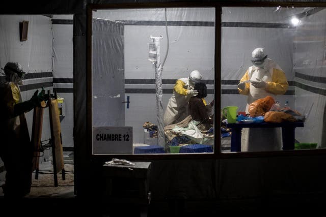 Health workers treat an unconfirmed Ebola patient, inside a treatment centre on November 3, 2018 in Butembo, Democratic Republic of the Congo