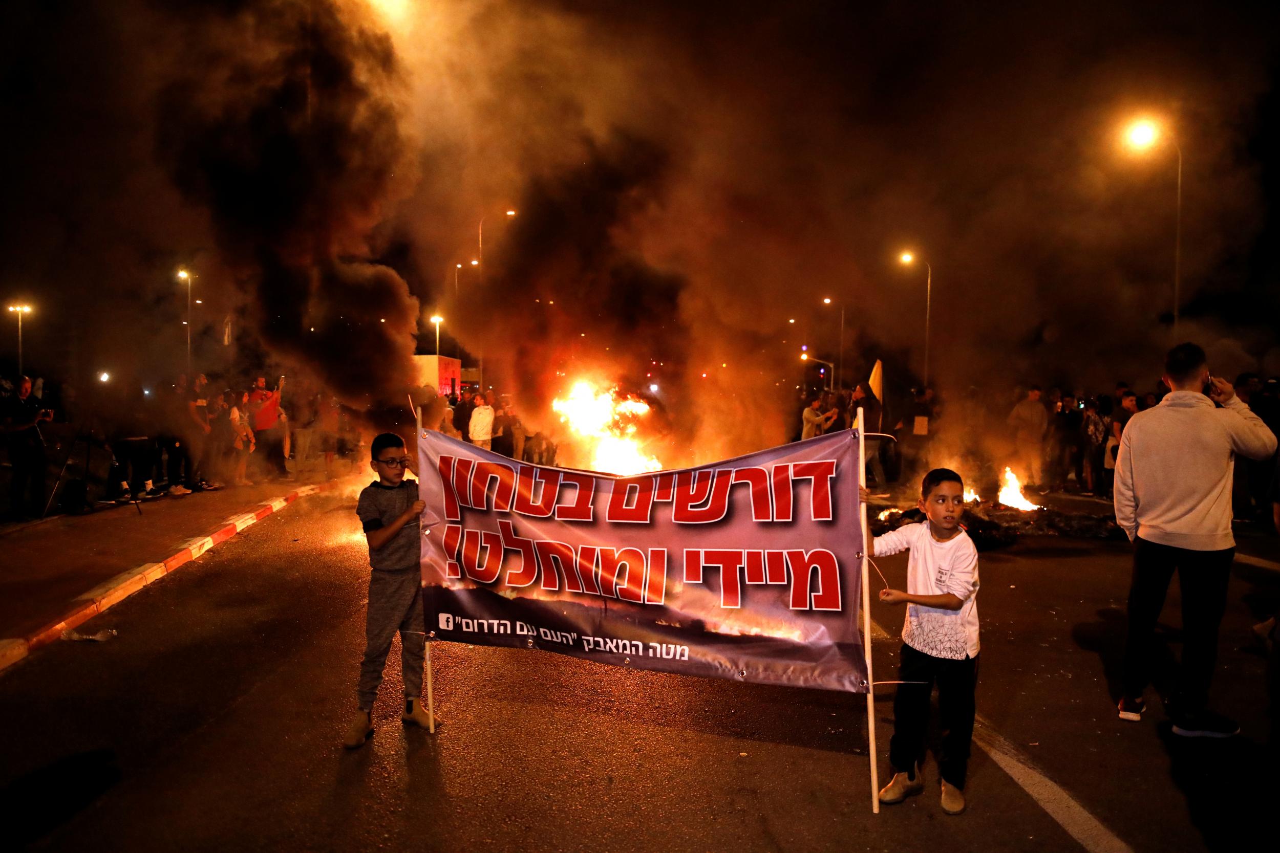Residents of southern Israel protest against their government's decision to hold fire in Gaza in response to a similar decision by Palestinian militants, in Sderot, Israel ( REUTERS/ Amir Cohen)