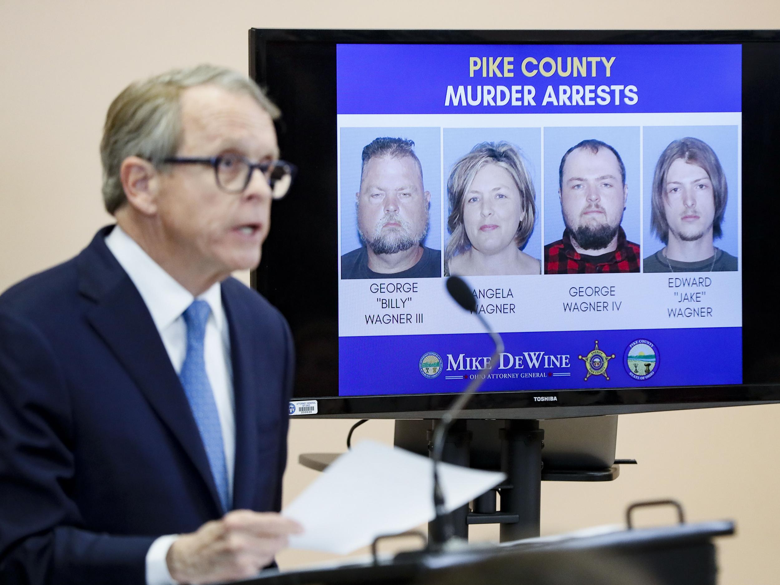 Ohio Attorney General Mike DeWine speaks alongside a display of those arrested during a news conference