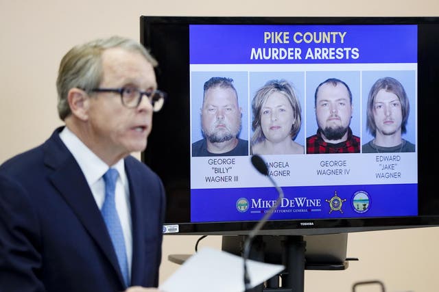 Ohio Attorney General Mike DeWine speaks alongside a display of those arrested during a news conference