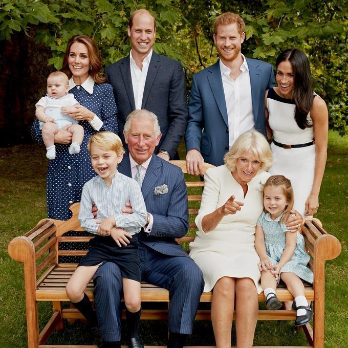 The whole family are pictured laughing in the second, more candid photograph (Chris Jackson/Clarence House)