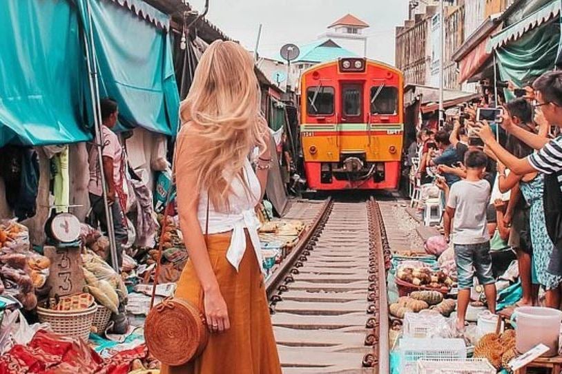 Patricia posed in front of a train at Maeklong Railway Market