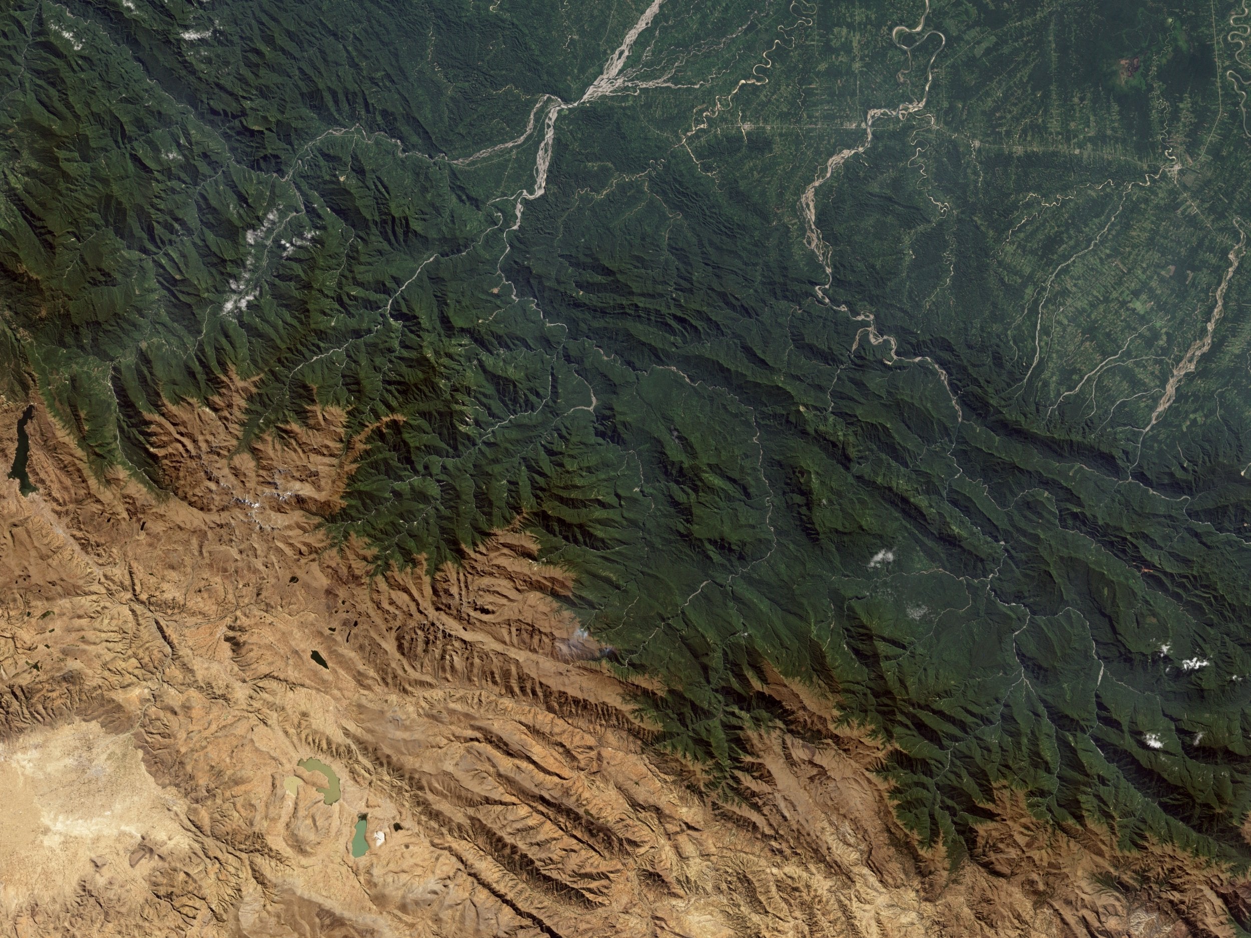 In the northeast of this satellite image of the Bolivian Andes, herringbone patterns show areas of deforestation