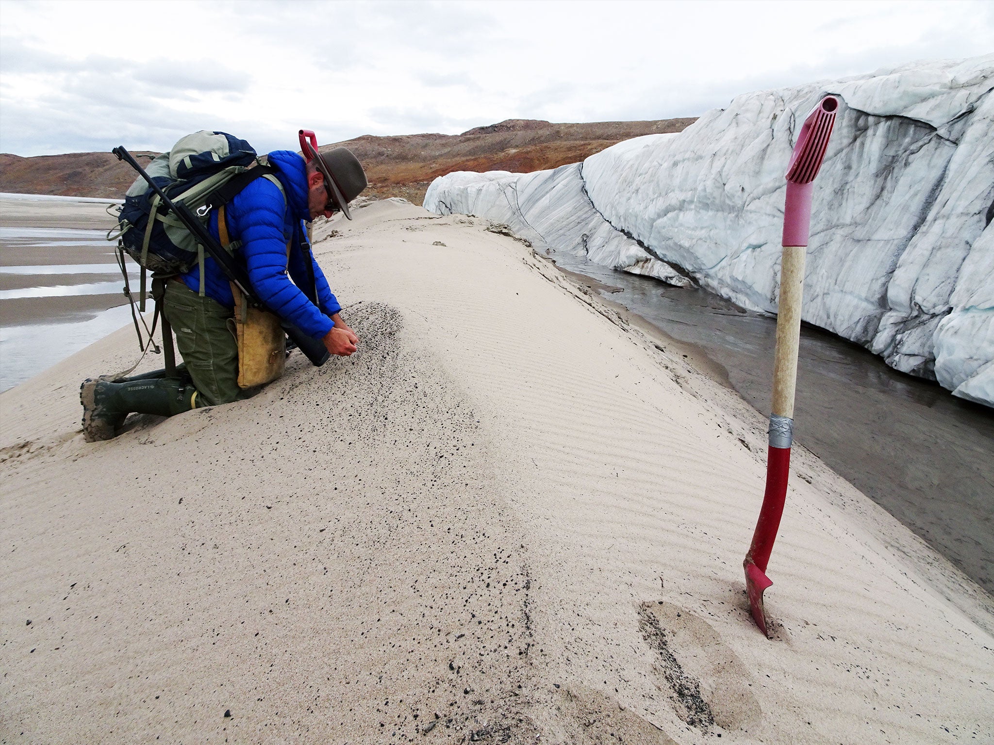 Kurt Kjær collecting sand samples at the front of Hiawatha Glacier. This sand was transported by the glacier from the bottom of the impact crater to the ice margin, and it has yielded a wealth of information on the impact