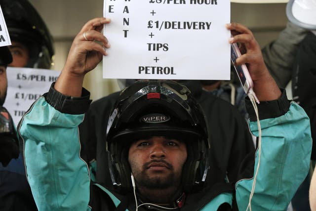 A Deliveroo driver protesting over rates of pay