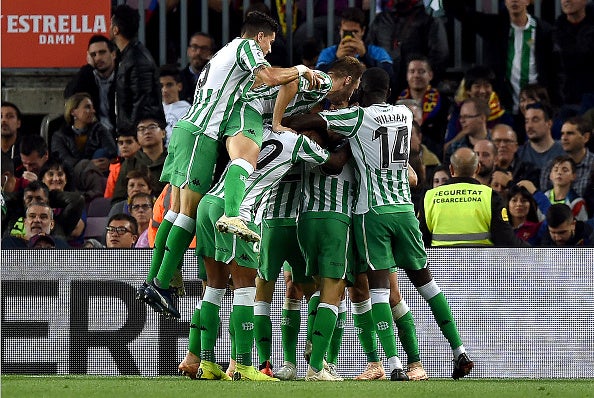 Real Betis players celebrate after scoring their third goal against Barcelona