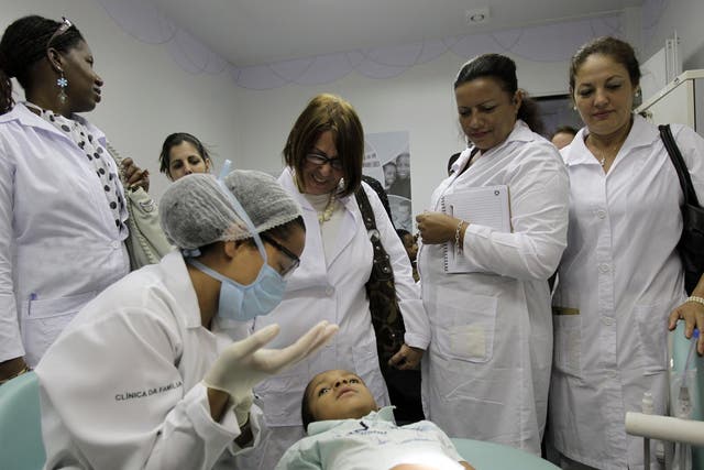 Cuban doctors observe a procedure at a health clinic in Brasilia, Brazil