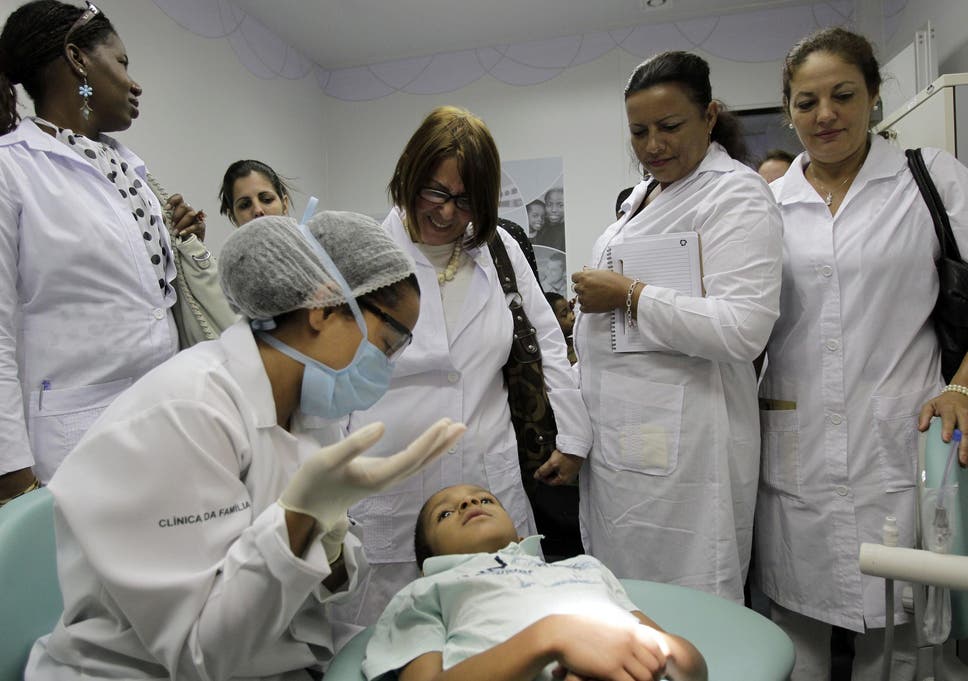 Cuban doctors observe a procedure at a health clinic in Brasilia, Brazil