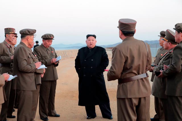In a photo released the North Korean government, Kim Jong-un, (centre), inspects the testing of an unspecified weapon at the Academy of National Defence Science, in North Korea
