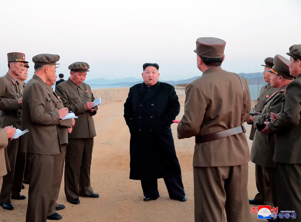 In a photo released the North Korean government, Kim Jong-un, (centre), inspects the testing of an unspecified weapon at the Academy of National Defence Science, in North Korea