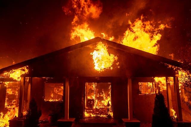 A home burns as the Camp Fire rages through Paradise, California
