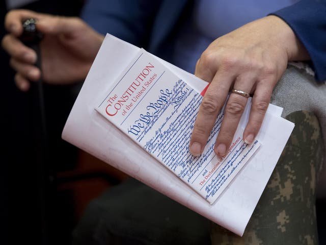 US Senator Tammy Duckworth, Democrat of Illinois, holds a pocket US Constitution