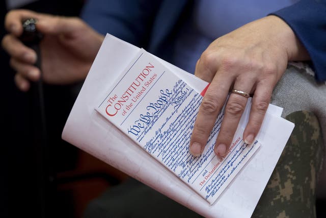 US Senator Tammy Duckworth, Democrat of Illinois, holds a pocket US Constitution