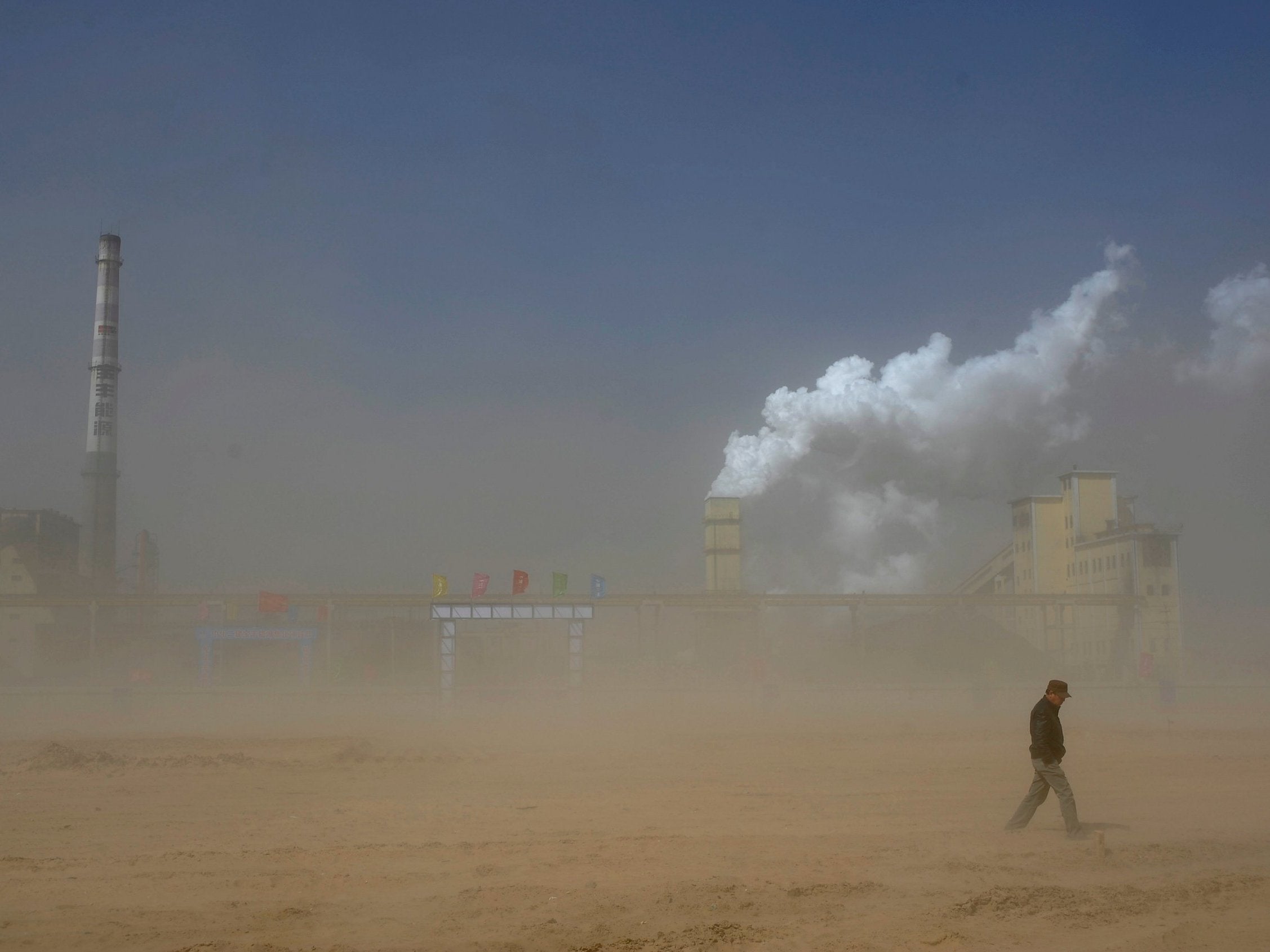 A coal plant partly obscured by a dust storm in China's Ningxia Hui autonomous region; the country is one of the worst offenders when it comes to emissions
