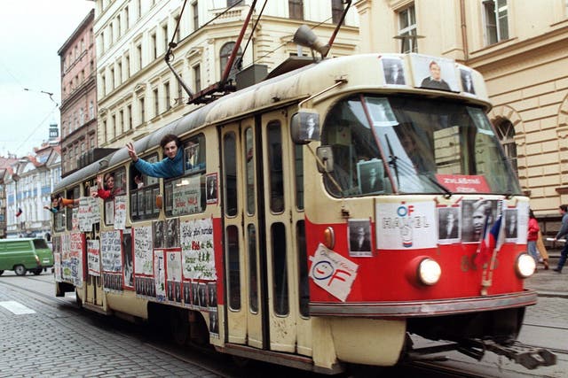 Young Czechoslovak people wave from a tramway in support of Vaclav Havel for presidency during a protest rally on 17 December 1989 near Wenceslas Square in Prague