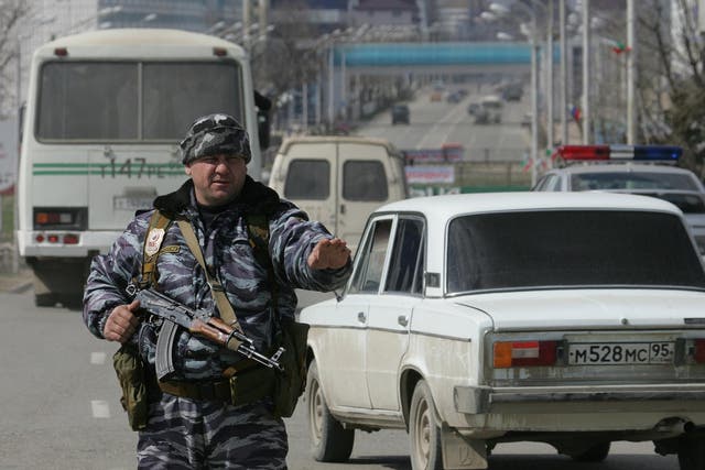 A Chechen policeman stands guard in Grozny