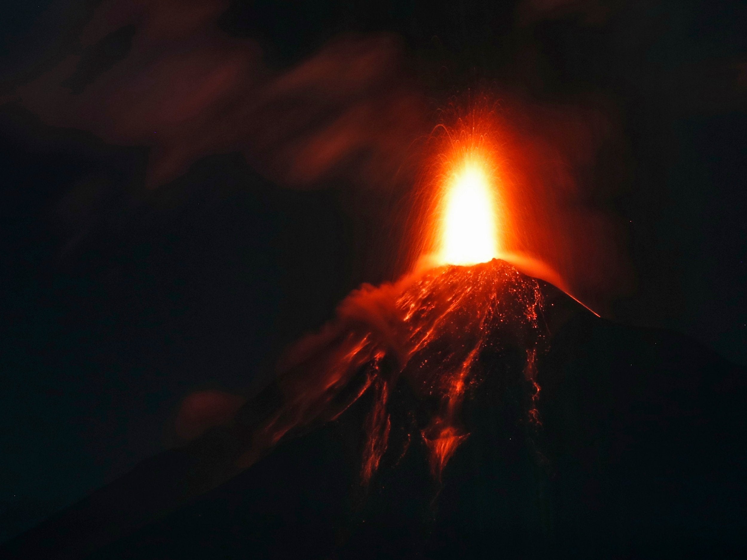 The Volcano of Fire spews hot molten lava from its crater in Antigua, Guatemala, early on Monday, 19 November