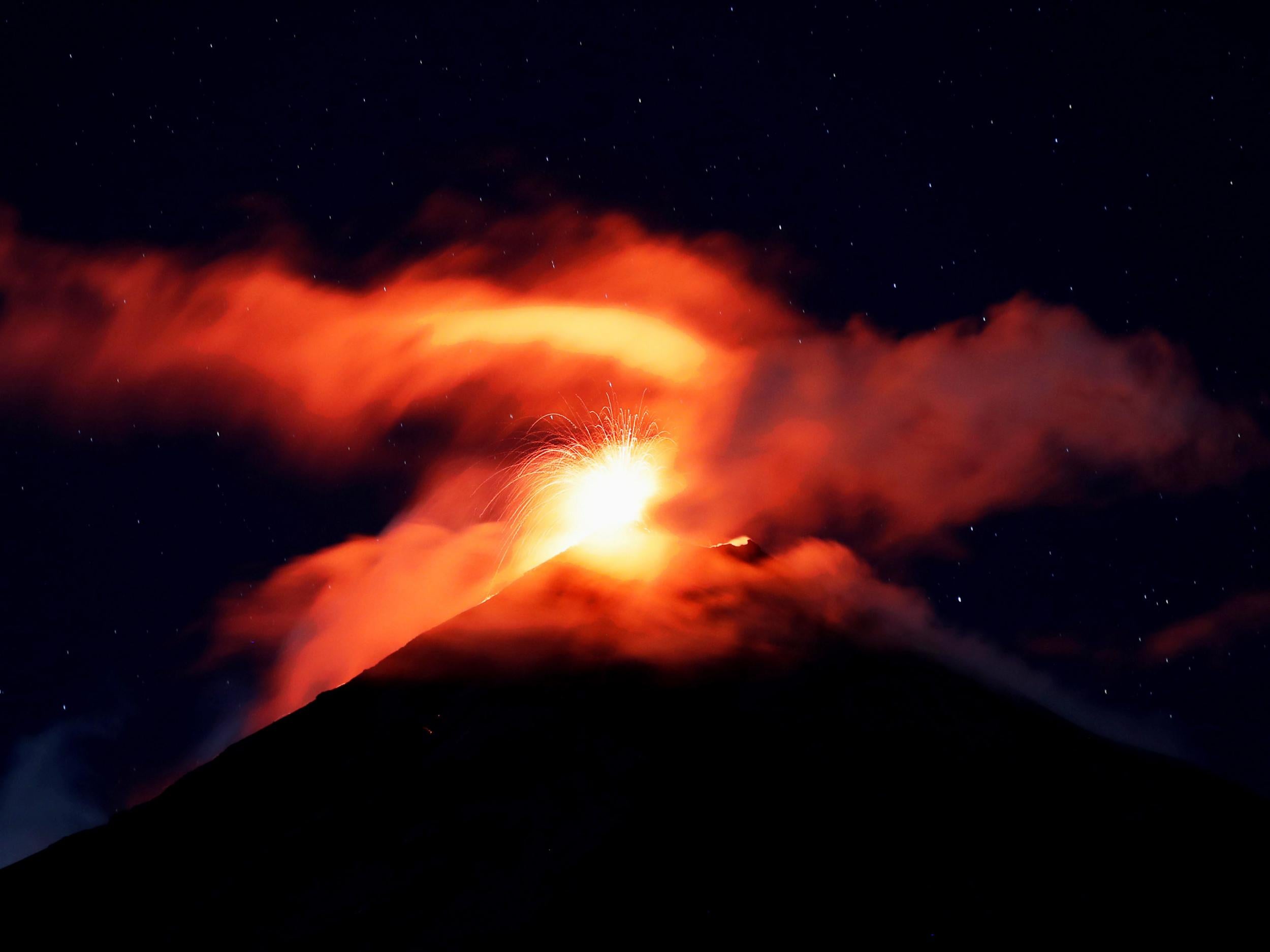 Volcano of Fire mount spews hot ashes and lava, as seen from Alotenango, Guatemala, on 18 November 2018