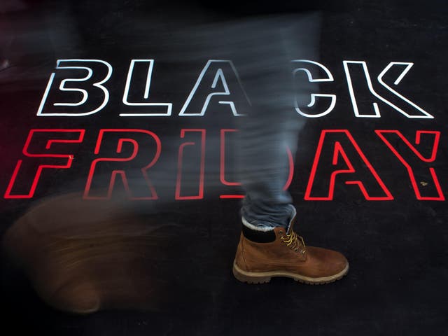 People walk over carpet to a Black Friday advertisement in front of a shop in Prague city center, Czech Republic, 24 November 2017