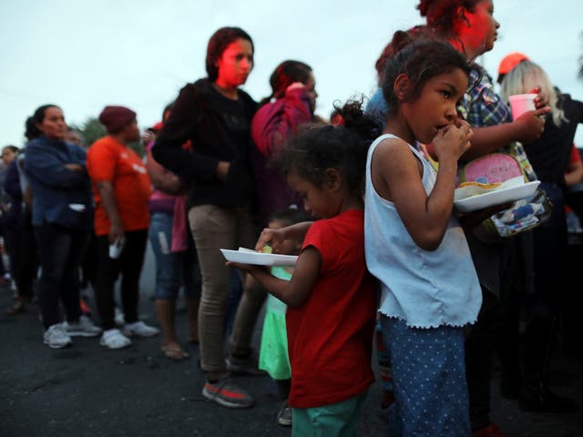 Central American migrants, part of caravan trying to reach the United States, wait to receive donated food in Mexicali, Mexico