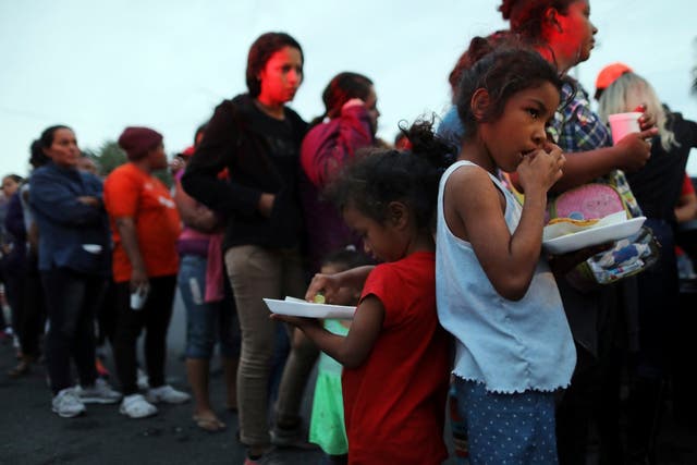 Central American migrants, part of caravan trying to reach the United States, wait to receive donated food in Mexicali, Mexico