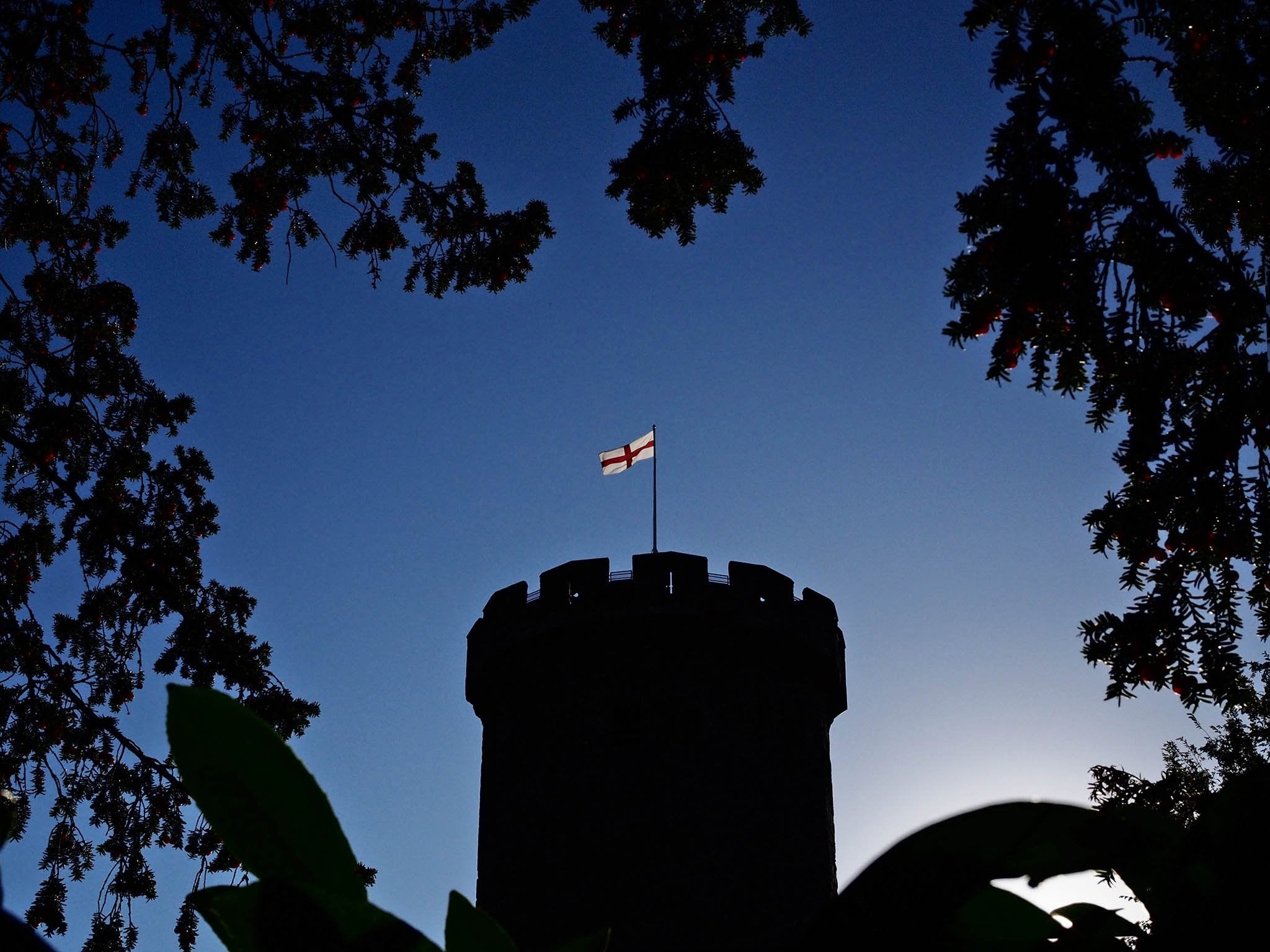 An early morning view of Warwick Castle, still black, just reappearing, yet the flag shines as if it had done so the whole night through, as if it had always been this way: a beacon of light in a world of darkness