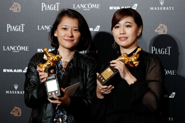 Fu Yue (right) poses with her Golden Horse award after delivering a controversial acceptance speech promoting Taiwanese independence