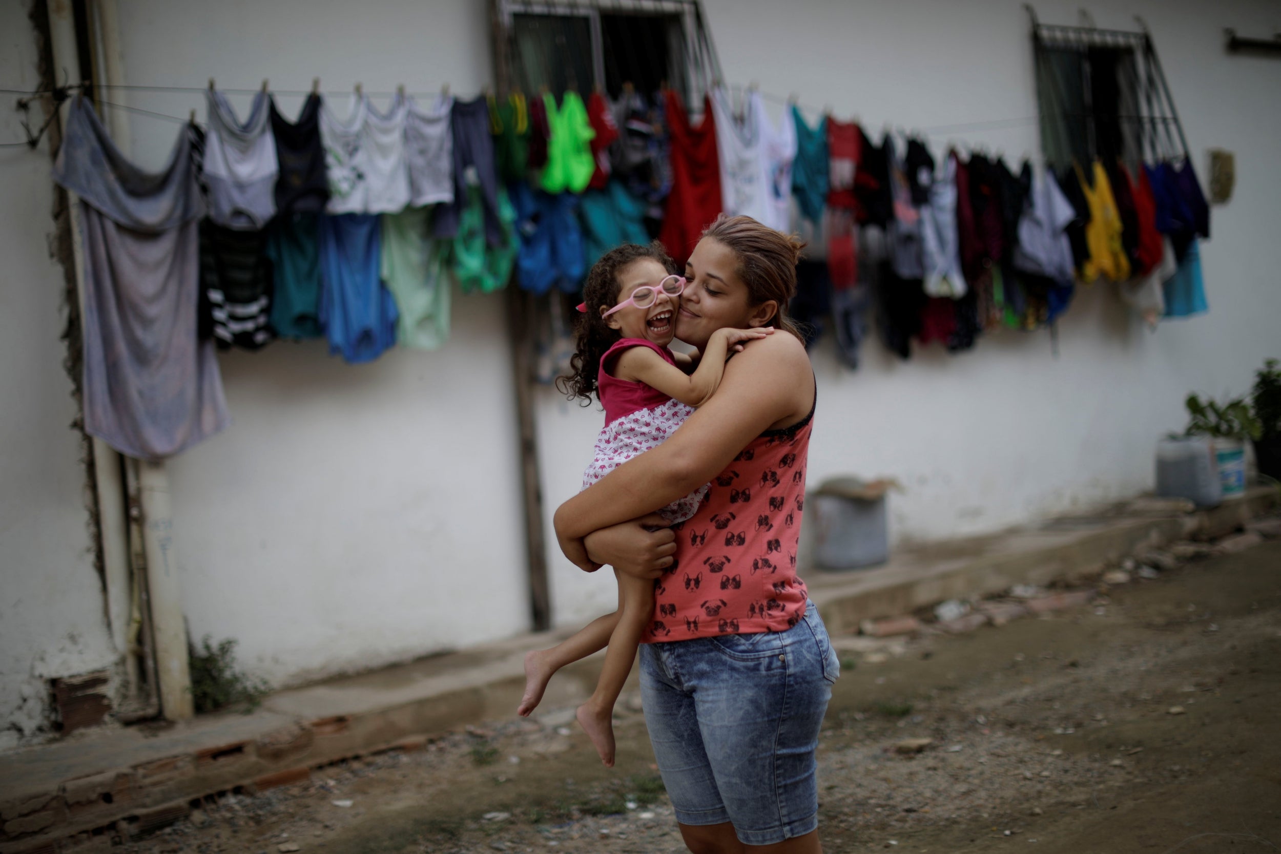 Gabriela holdsing her daughter Ana Sophia outside their house