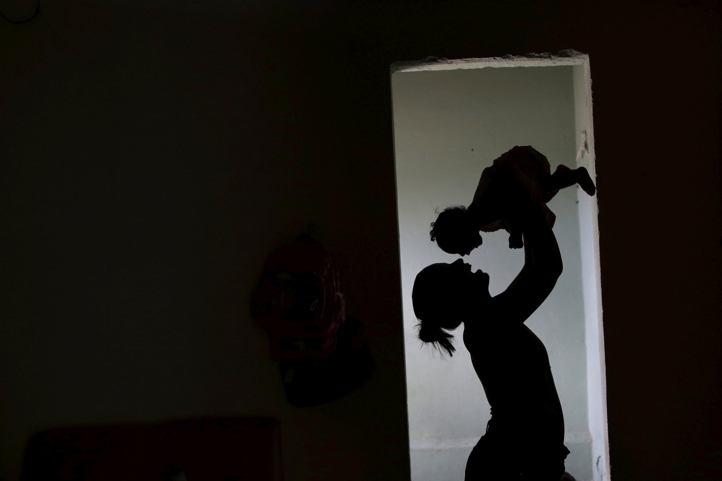 Rosana holds her daughter Luana Vieira, who was born with microcephaly, at their house in 2016