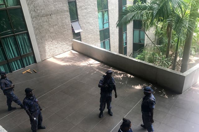 Police and soldiers guard the outside of parliament in Port Moresby after earlier, protesters stormed the building in a pay row