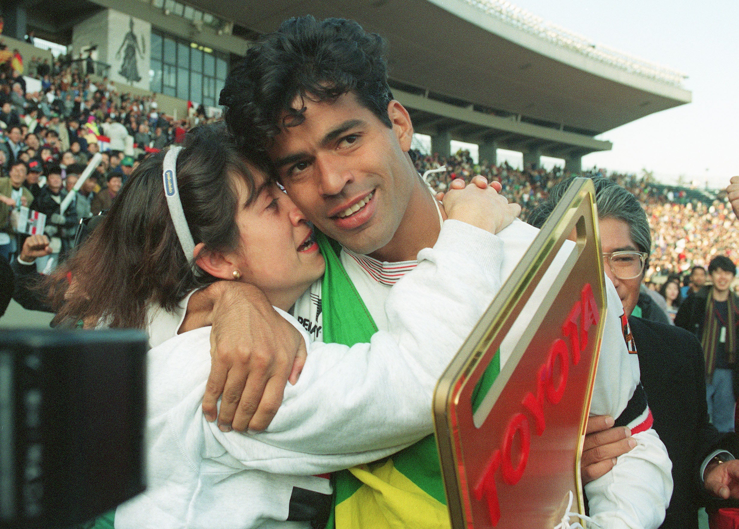 Sao Paulo captain and star striker Rai (R) hugs his wife after his team won the Inter-Continental Cup in 1992