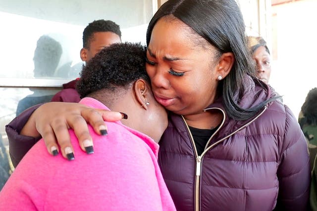 Bernice Parks, left, being consoled after her daughter Sandra Parks, 13, was killed by a stray bullet flying into her bedroom